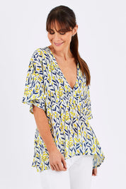 Model Monique wearing size 10 of the Tystnad Blouse in colour YellowPtl, from the front, cropped image