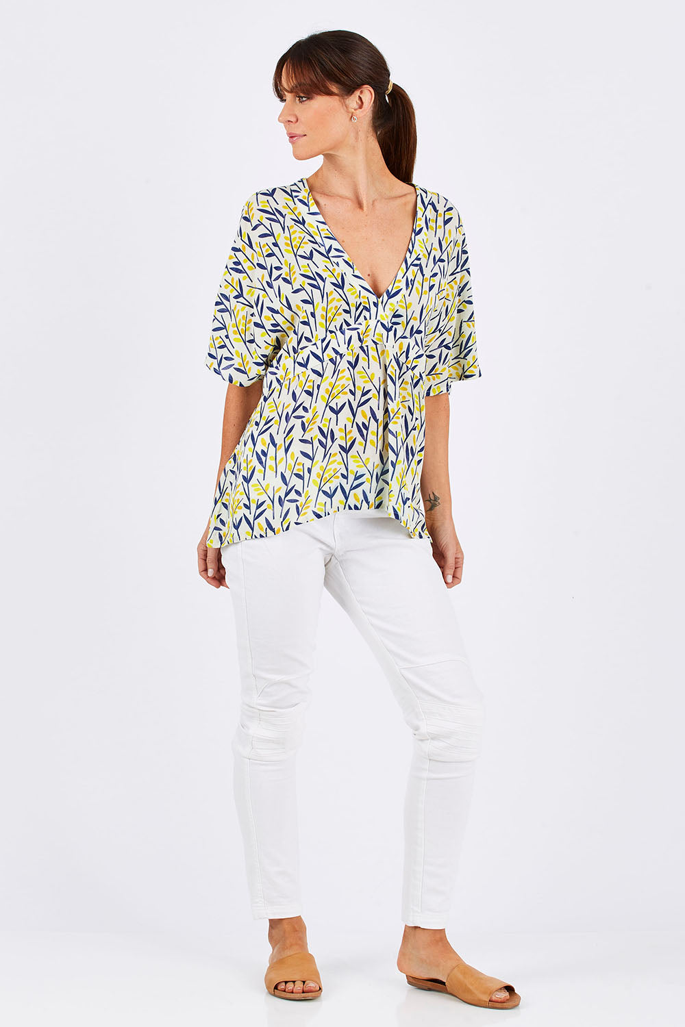 Model Monique wearing size 10 of the Tystnad Blouse in colour YellowPtl, from the front, showing the whole outfit