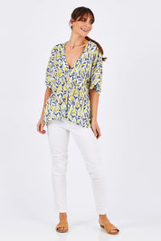 Model Monique wearing size 10 of the Tystnad Blouse in colour YellowPtl, from the front, showing the whole outfit