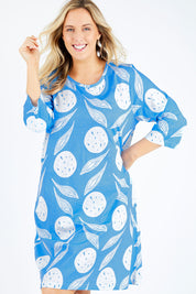 Model Jess wearing size 14 of the Dagtig Dress in colour Circflwr (White), from the front, cropped image