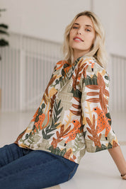 Model Phoebe wearing size 10 of the Avslappnad Top in colour Animal (Green), from the front, showing the whole outfit