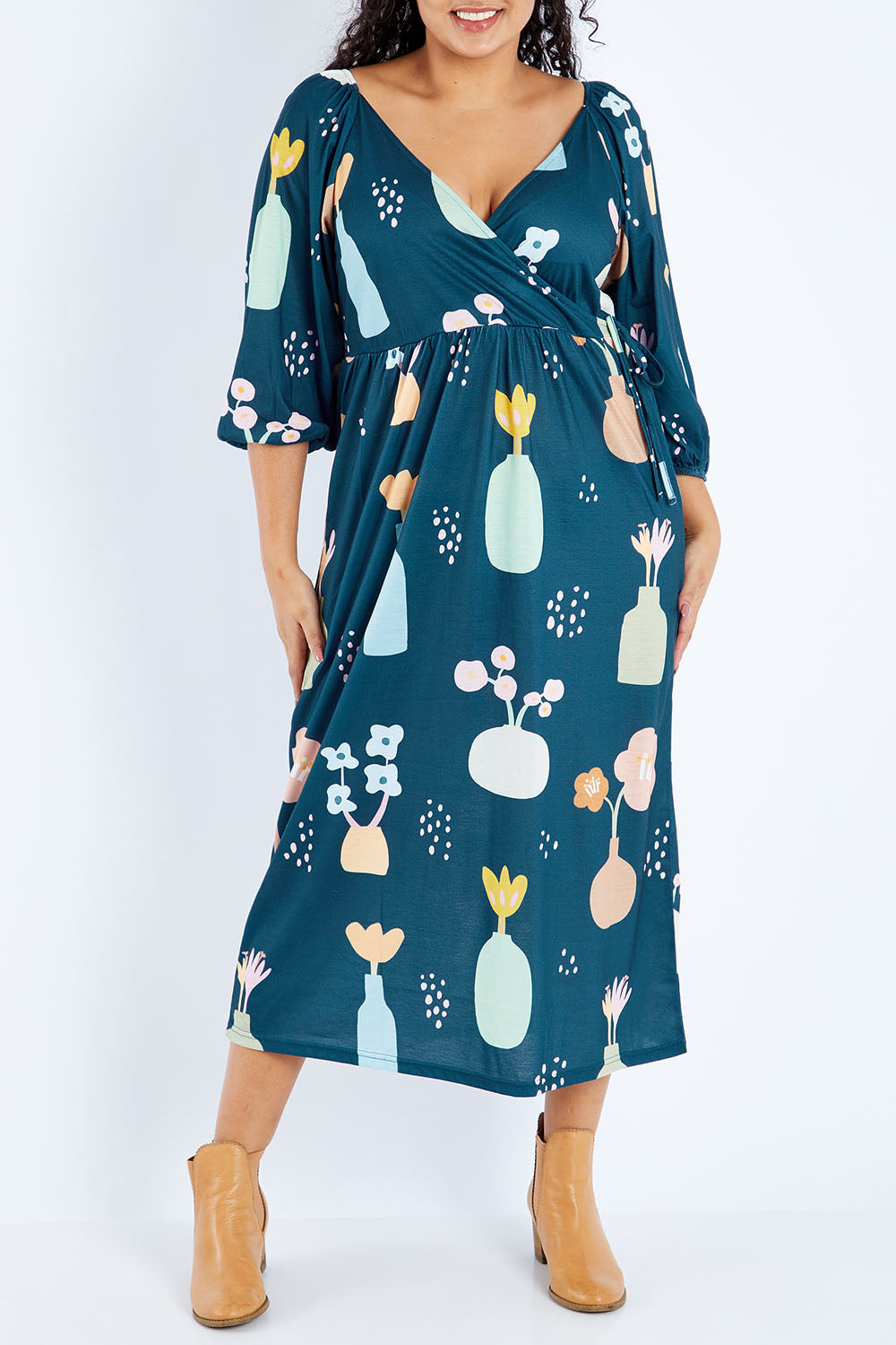 Model Sasha-Lee wearing size 16 of the Romantik Dress in colour Vases (Blue), from the front, cropped image