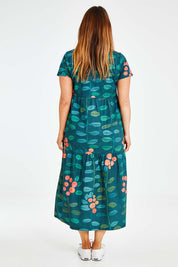 Model Laura wearing size 14 of the Stegs Dress in colour Navjuniper (Blue), from the back