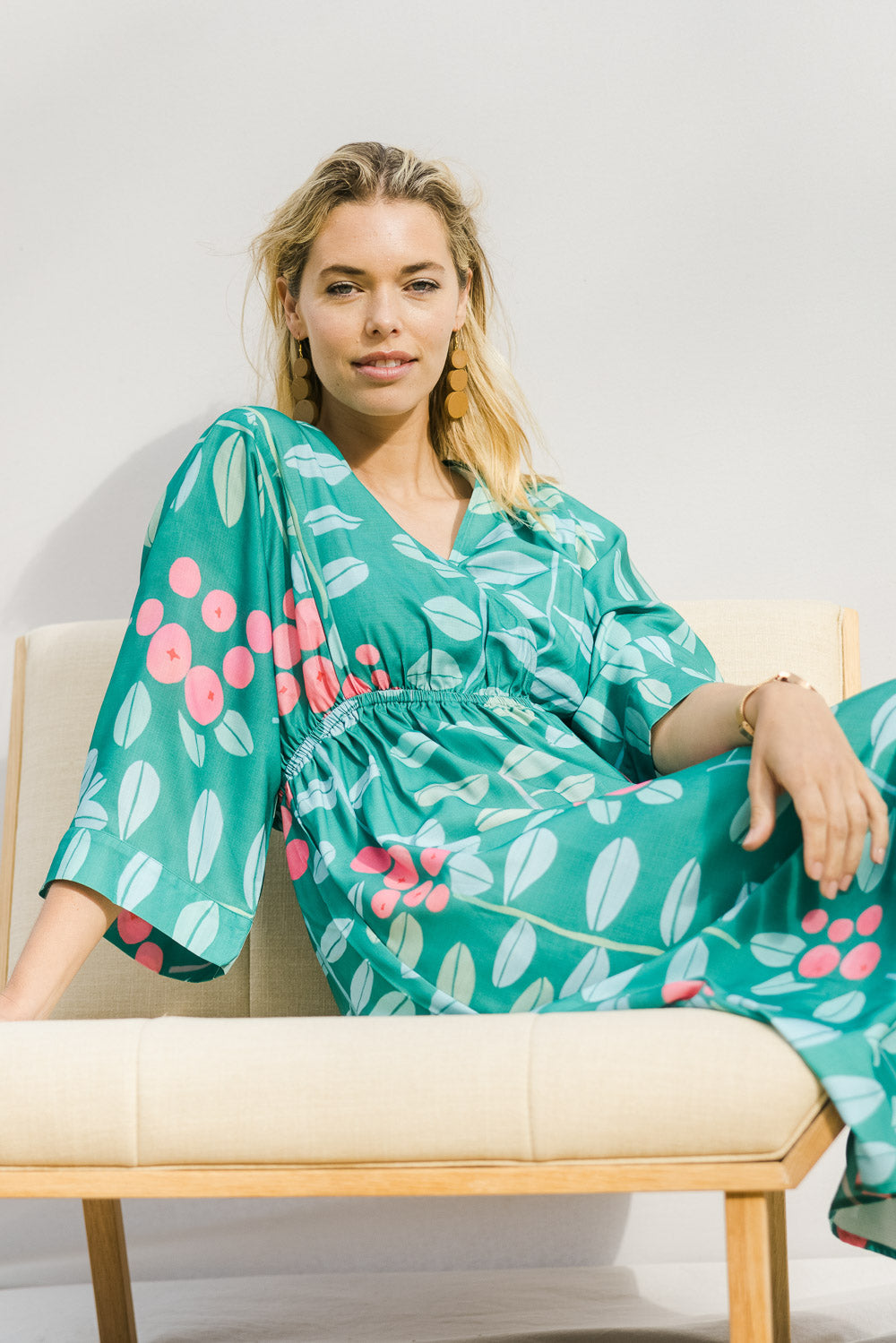 Model Phoebe wearing size 10 of the Middag Dress in colour Grejuniper (Green), from the front, showing the whole outfit
