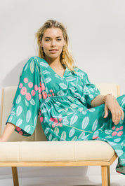Model Phoebe wearing size 10 of the Middag Dress in colour Grejuniper (Green), from the front, showing the whole outfit