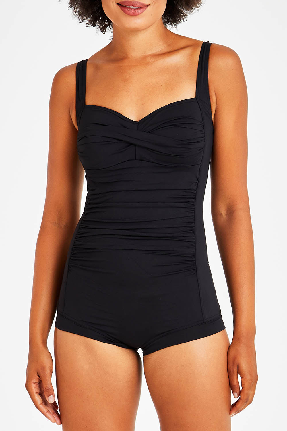 Model Olivia wearing size 10 of the Boyleg Maillot in colour Black (Black), from the front, cropped image