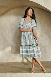 Model Tahneei wearing size 10 of the Cocora Valley Cotton Dress – Olive in colour Olive, from the front
