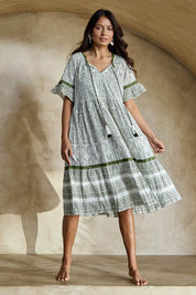 Model Tahneei wearing size 10 of the Cocora Valley Cotton Dress – Olive in colour Olive, from the front
