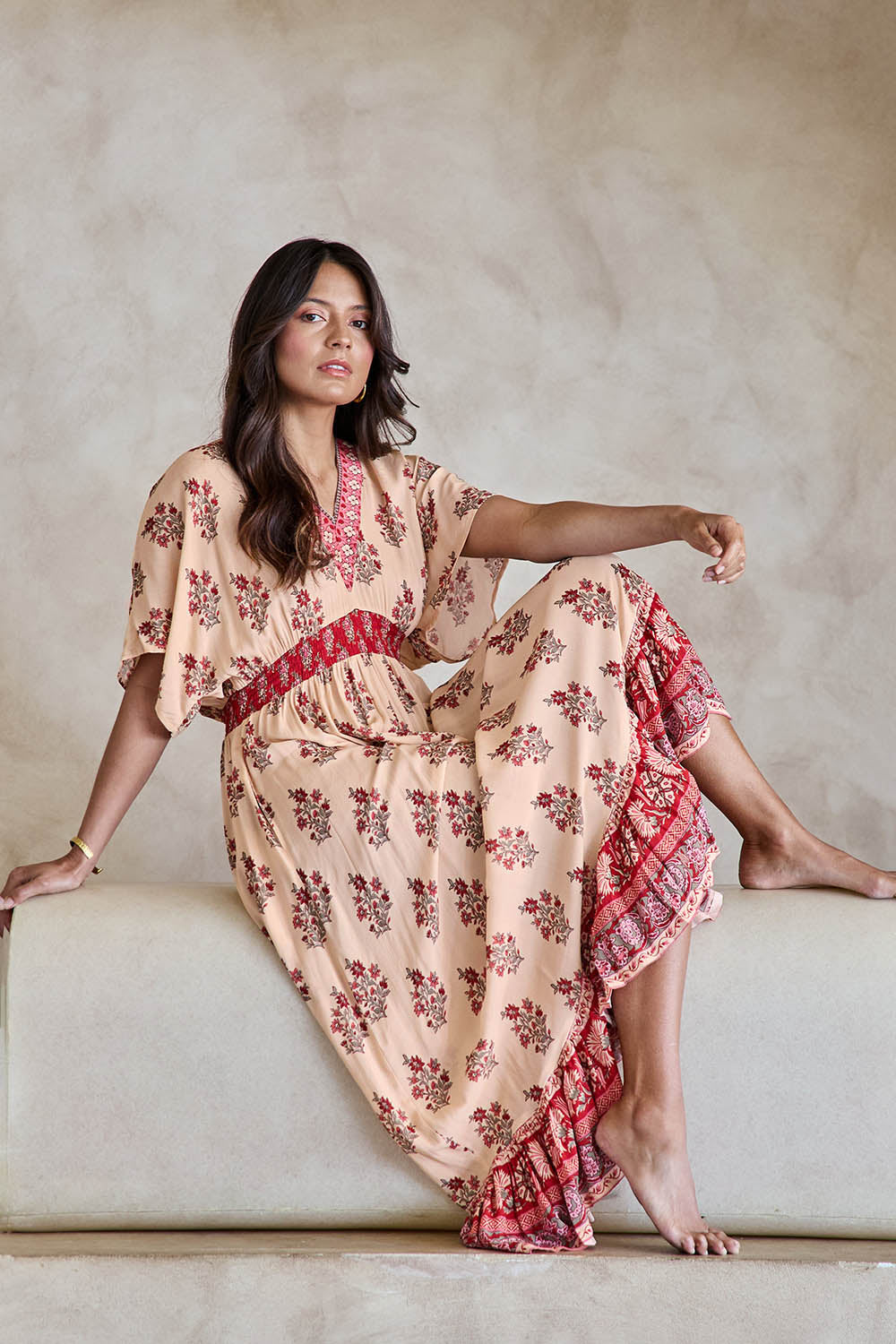 Model Tahneei wearing size 10 of the Pacific Beach Long Dress – Redcream in colour Redcream, from the front