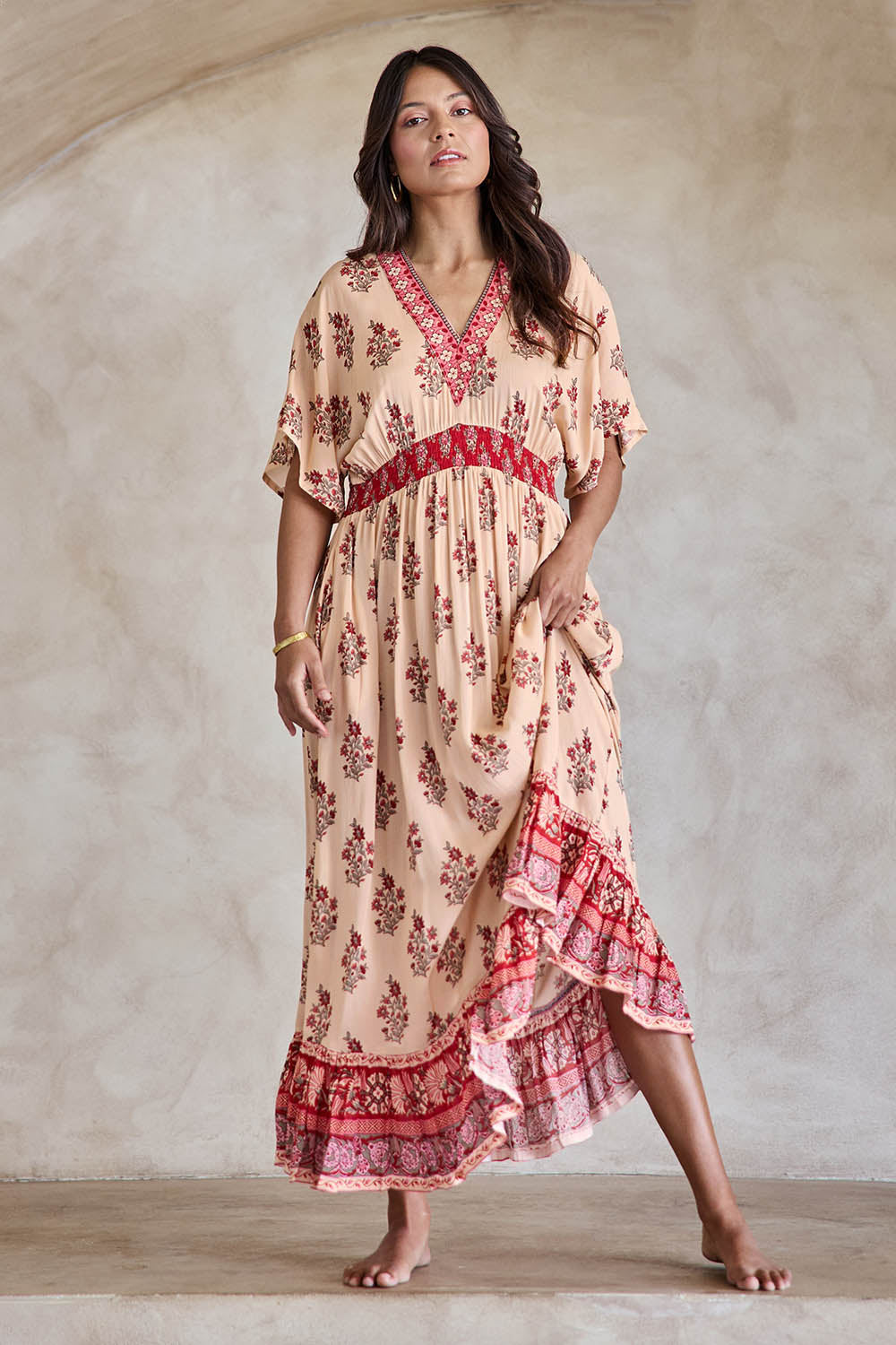 Model Tahneei wearing size 10 of the Pacific Beach Long Dress – Redcream in colour Redcream, from the front
