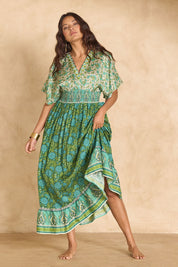Model Tahnee wearing size 10 of the Pacific Beach Long Dress in colour Whitegreen (Green), from the front, showing the whole outfit