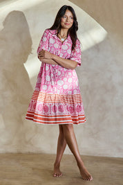 Model Tahneei wearing size 10 of the Wineglass Bay Cotton Dress – Pinkorange in colour Pinkorange, from the front