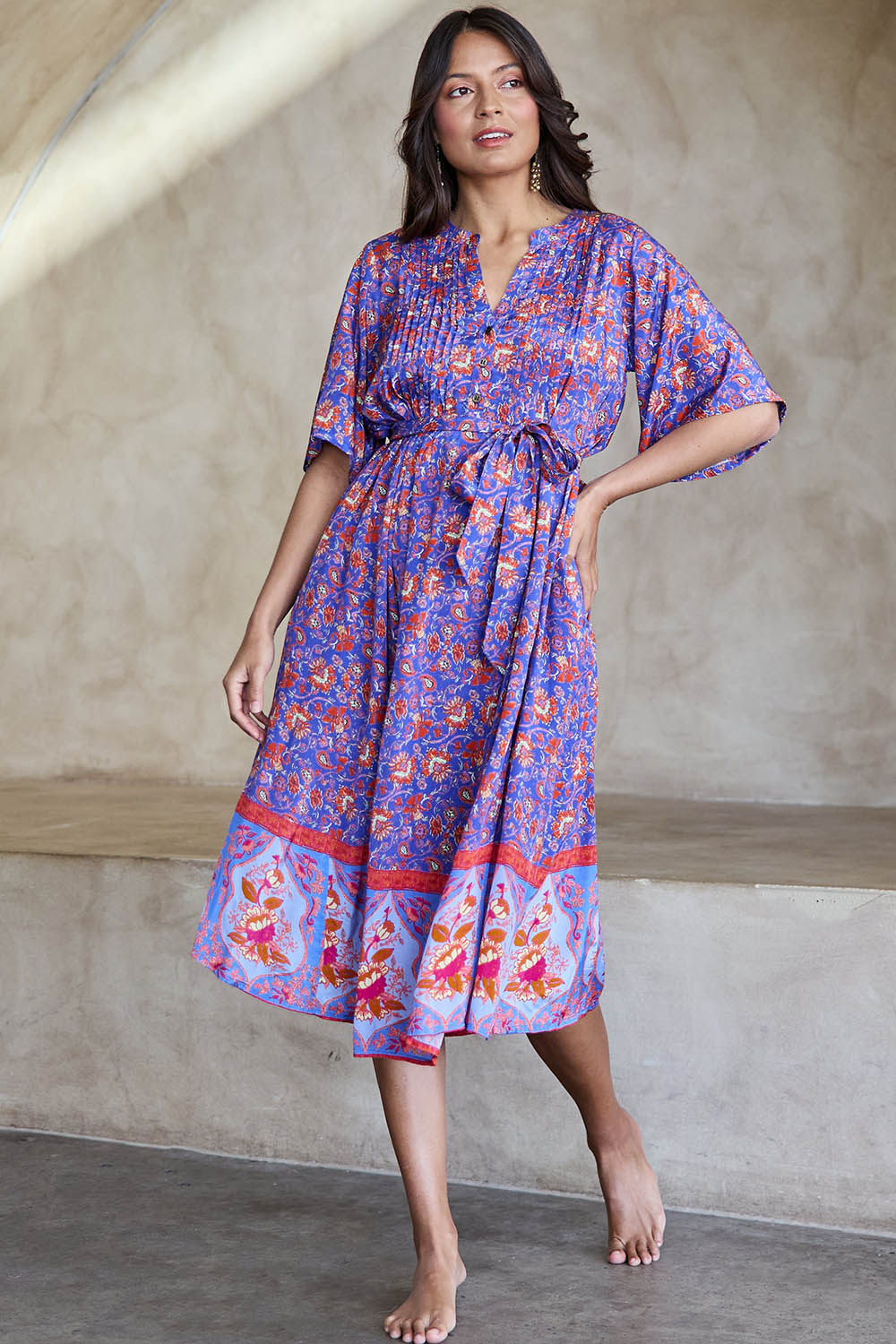 Model Tahneei wearing size 10 of the Turquoise Bay Dress – Rose in colour Rose, from the front