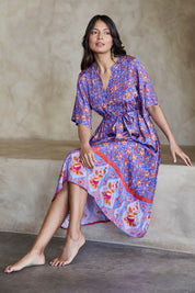 Model Tahneei wearing size 10 of the Turquoise Bay Dress – Rose in colour Rose, from the front