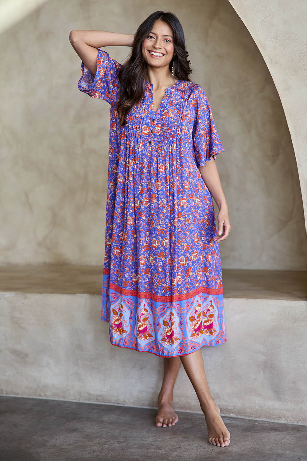 Model Tahneei wearing size 10 of the Turquoise Bay Dress – Rose in colour Rose, from the front
