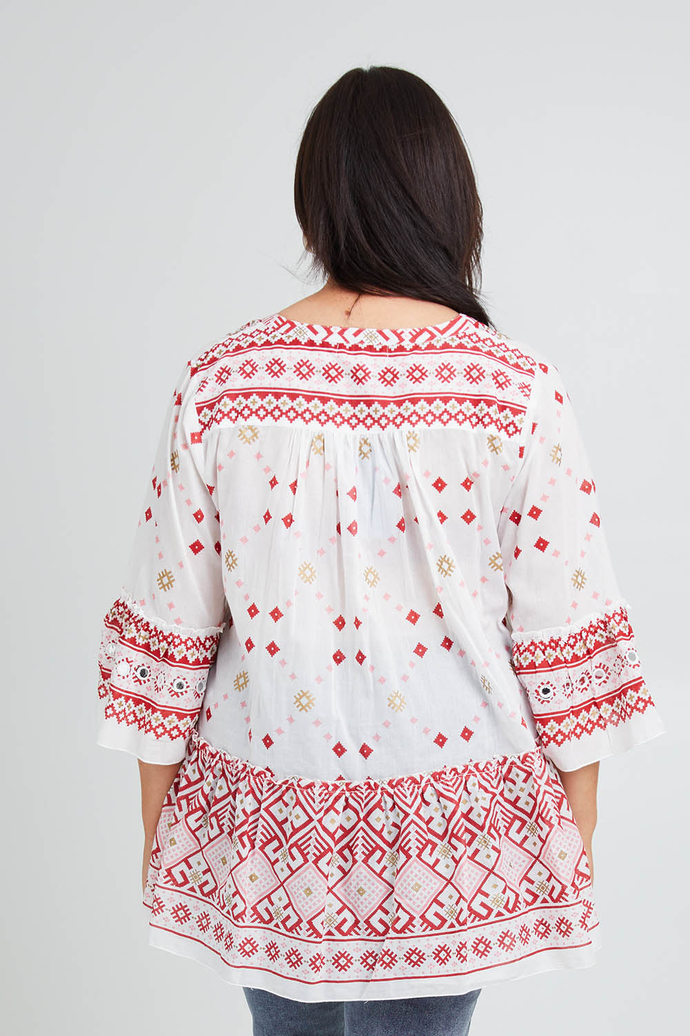 Model Poppy wearing size 16 of the Avalon Beach Blouse in colour Pinkred (Pink), from the back