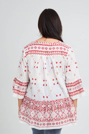 Model Poppy wearing size 16 of the Avalon Beach Blouse in colour Pinkred (Pink), from the back