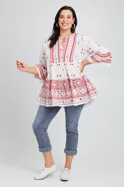 Model Poppy wearing size 16 of the Avalon Beach Blouse in colour Pinkred (Pink), from the front, showing the whole outfit