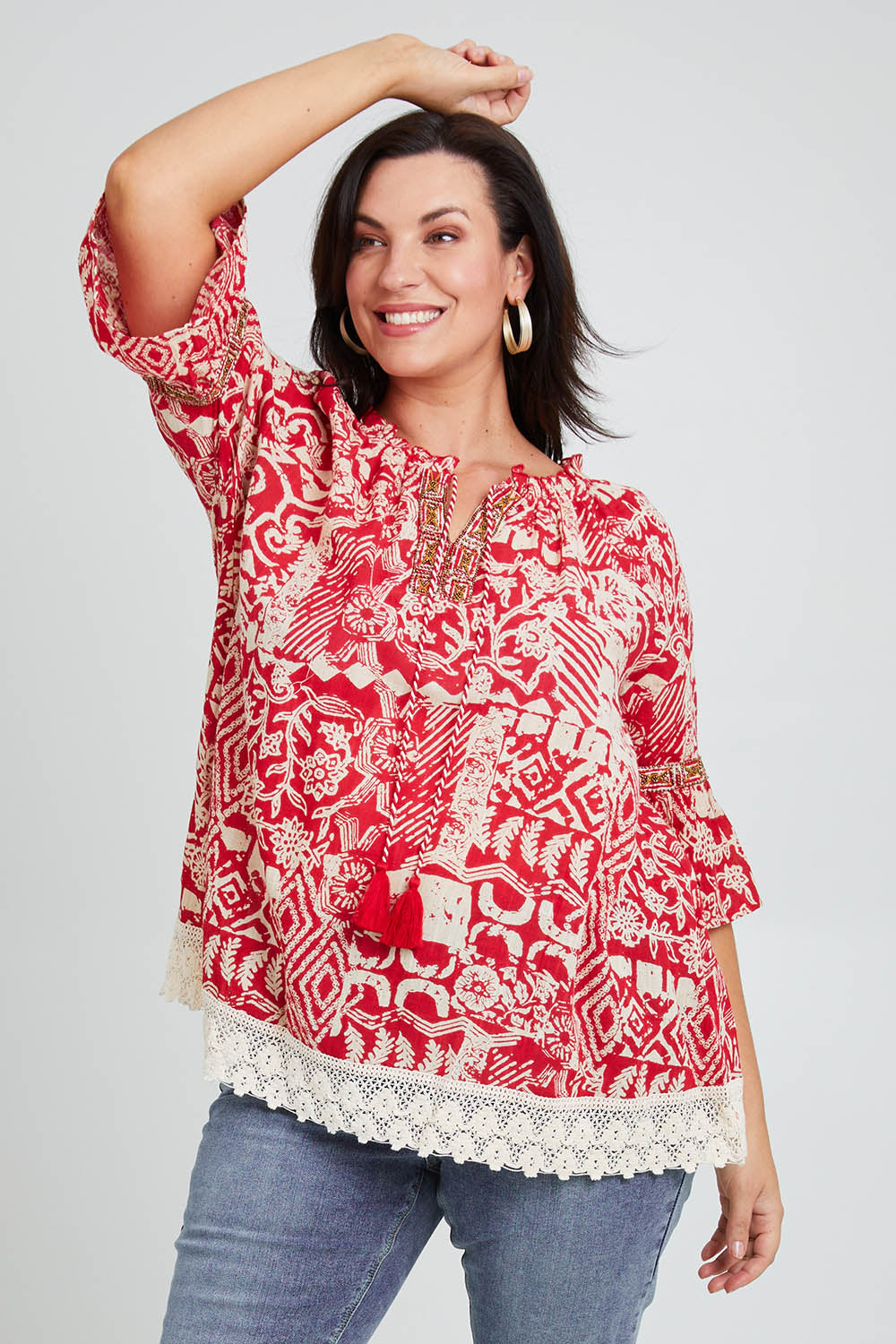 Model Poppy wearing size 16 of the Maroubra Beach Cotton Blouse in colour Red (Red), from the front, cropped image