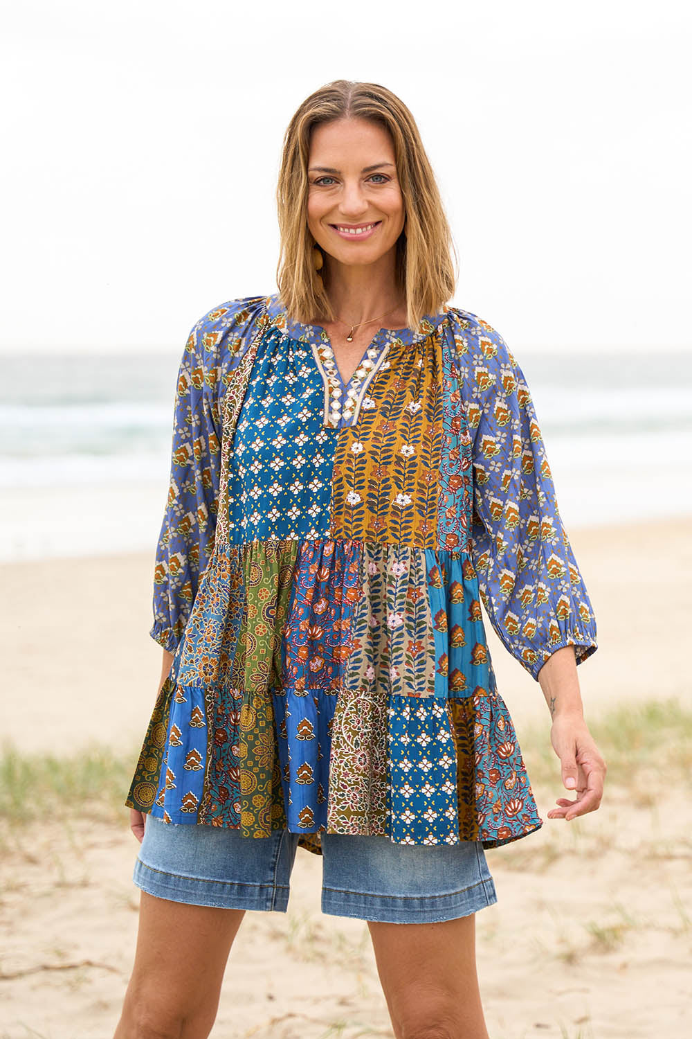 Model Riina wearing size 10 of the Brighton Beach Top in colour Patchblue (Blue), from the front, showing the whole outfit