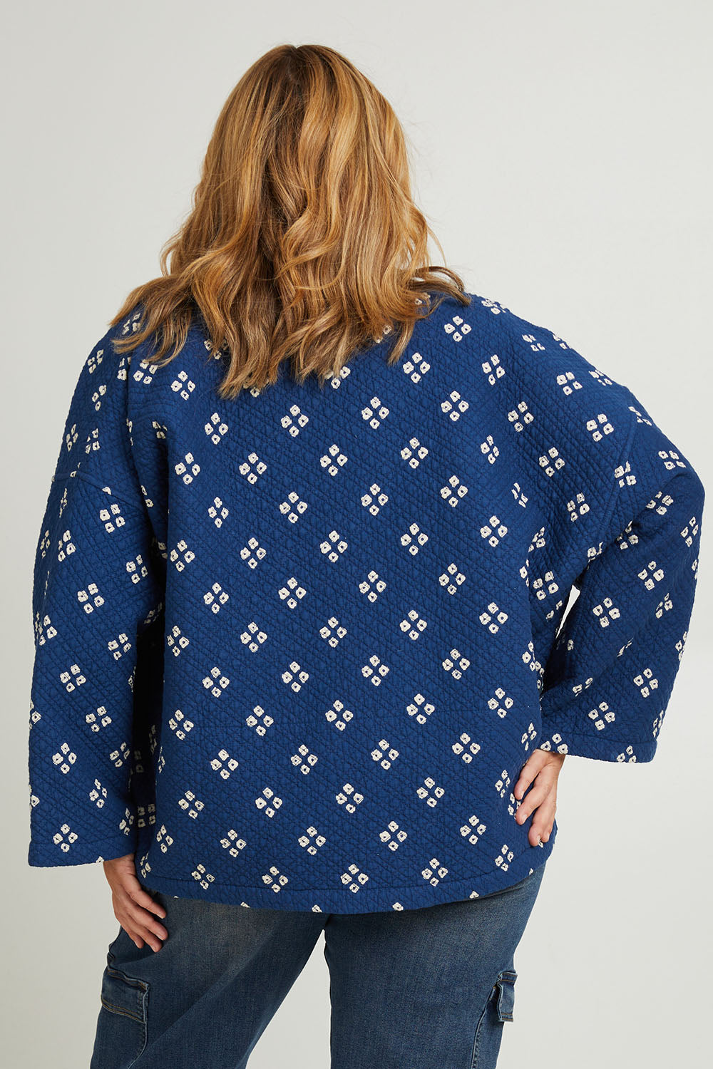 Model Fiona wearing size 16 of the Nightcliff Beach Jacket in colour Navy (Blue), from the back