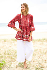 Model Riina wearing size 10 of the Balmoral Beach Top in colour Rust (Red), from the front, showing the whole outfit
