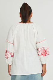 Model Ashleigh wearing size 16 of the Whitehaven Beach Cotton Blouse in colour Whitepink (White), from the back