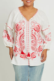 Model Ashleigh wearing size 16 of the Whitehaven Beach Cotton Blouse in colour Whitepink (White), from the front, cropped image
