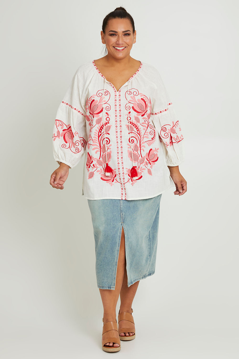 Model Ashleigh wearing size 16 of the Whitehaven Beach Cotton Blouse in colour Whitepink (White), from the front, showing the whole outfit