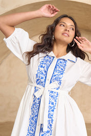 Model Tahnee wearing size 10 of the Ipanema Beach Cotton Embroidered Dress in colour Whiteblue (Blue), from the front, cropped image