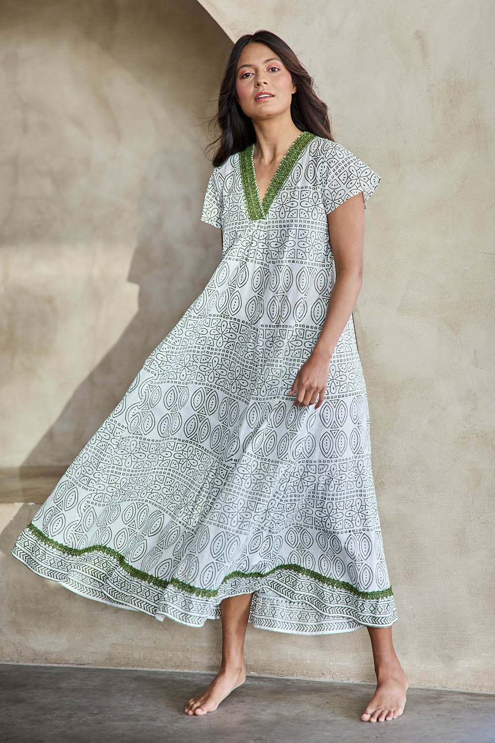 Model Tahneei wearing size 10 of the Cocora Valley Cotton Long Dress – Olive in colour Olive, from the front