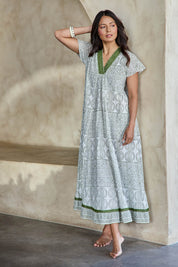 Model Tahneei wearing size 10 of the Cocora Valley Cotton Long Dress – Olive in colour Olive, from the front