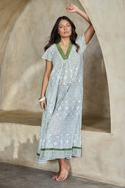 Model Tahneei wearing size 10 of the Cocora Valley Cotton Long Dress – Olive in colour Olive, from the front