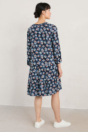 A model wearing the Proctor Dress in colour Hellcoll (Blue), from the back