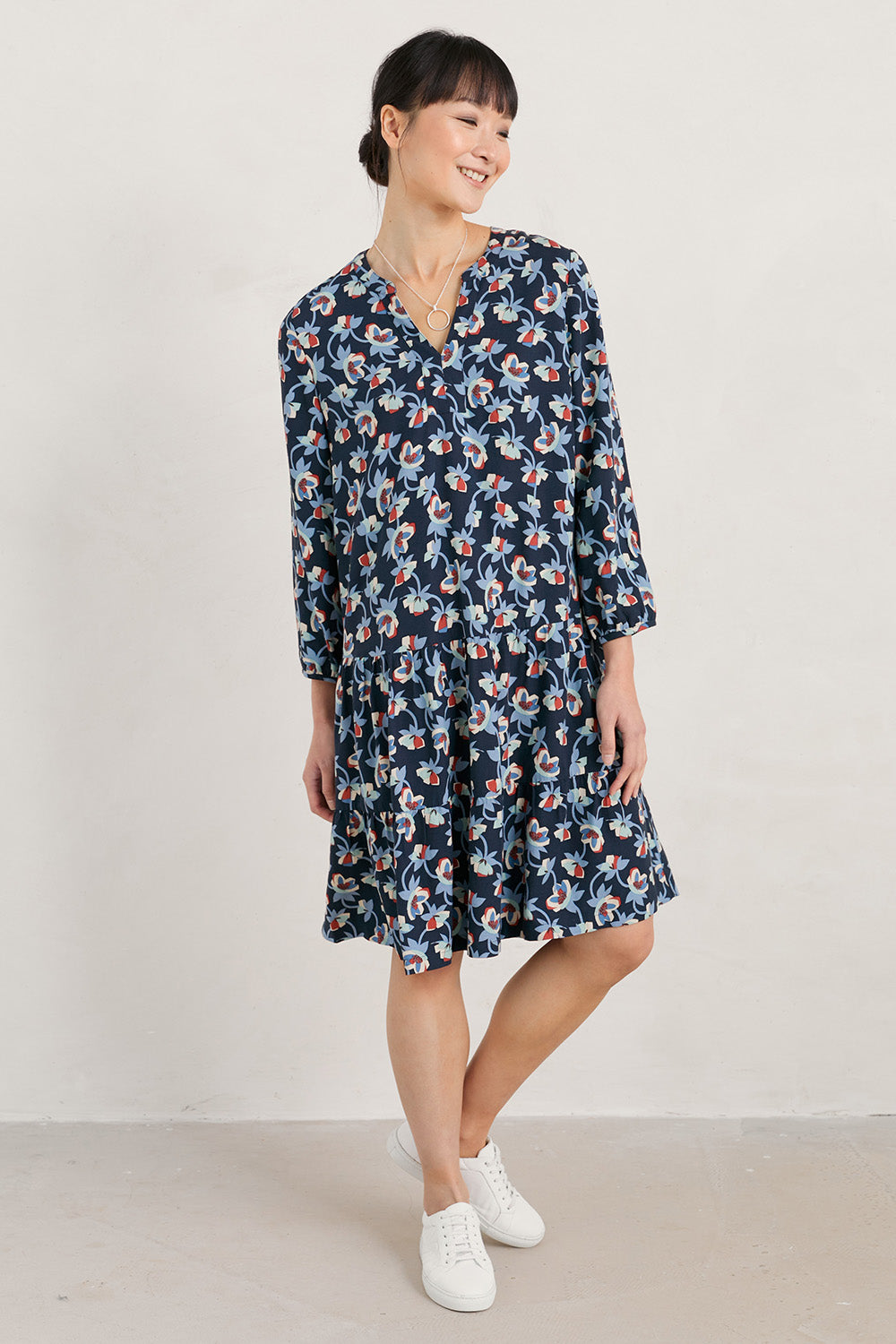 A model wearing the Proctor Dress in colour Hellcoll (Blue), from the front, showing the whole outfit