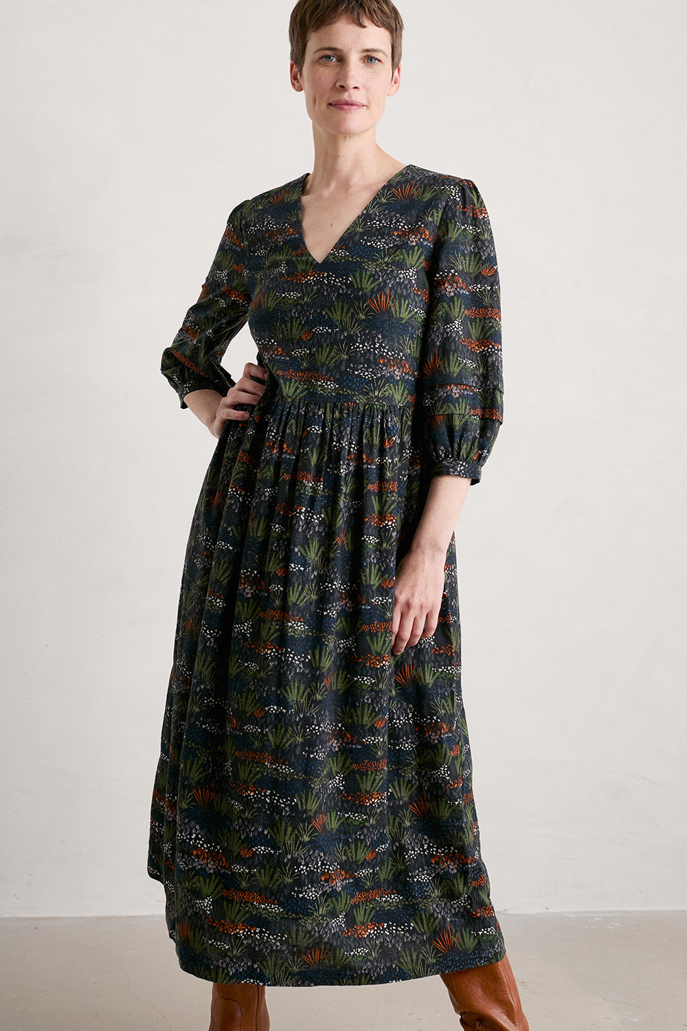 A model wearing the Sea Line Dress in colour Moormeadow (Black), from the front, cropped image