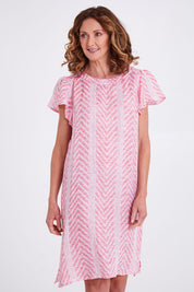 Model Emma wearing size 10 of the Flutter Sleeve Dress in colour Redwhite (Red), from the front, cropped image