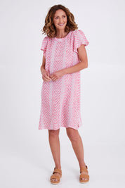 Model Emma wearing size 10 of the Flutter Sleeve Dress in colour Redwhite (Red), from the front, showing the whole outfit