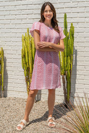 A model wearing the Flutter Sleeve Dress in colour Redwhite (Red), from the front, showing the whole outfit