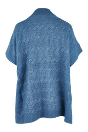 Product shot of the Lambswool Blend Cable Poncho in colour Denim (Blue), from the back