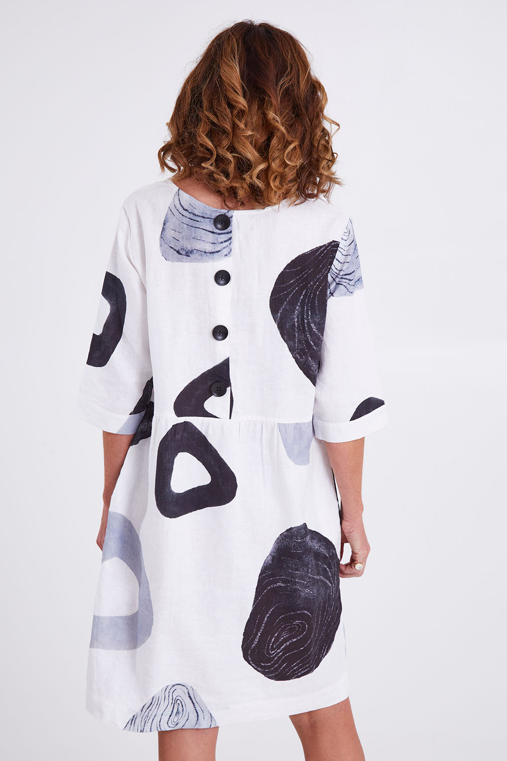 Model Emma wearing size 10 of the Linen 3/4 Sleeve Dress in colour Achromatic (White), from the back
