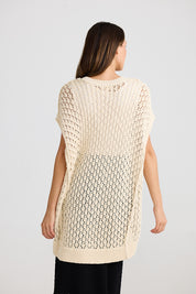 A model wearing the Kasbah Top in colour Natural, from the back