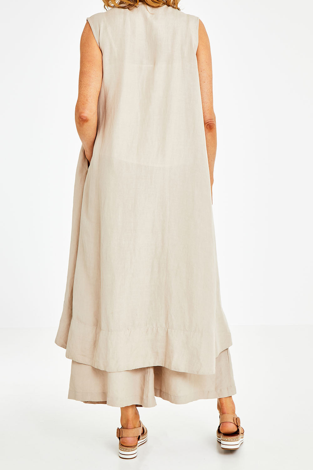 Model Naomi wearing the Neopolitan Long Vest in colour Natural, from the back