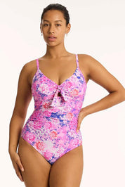 A model wearing the Tie Front Dd/E One Piece in colour Pink (Pink), from the front, cropped image