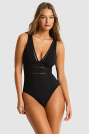 A model wearing the Spliced One Piece in colour Black (Black), from the front, cropped image