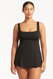 A model wearing the Square Neck Tummy Control Swim Dress in colour Black (Black), from the front, cropped image