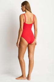A model wearing the Eco Essentials Cross Front One Piece in colour Red (Red), from the back