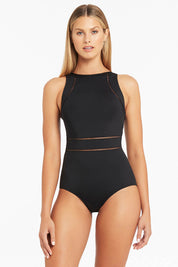 A model wearing the High Neck Multifit One Piece in colour Black (Black), from the front, cropped image
