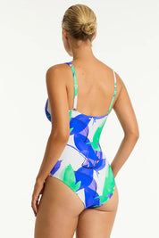A model wearing the Cross Front Multifit One Piece in colour Cobalt (Blue), from the back