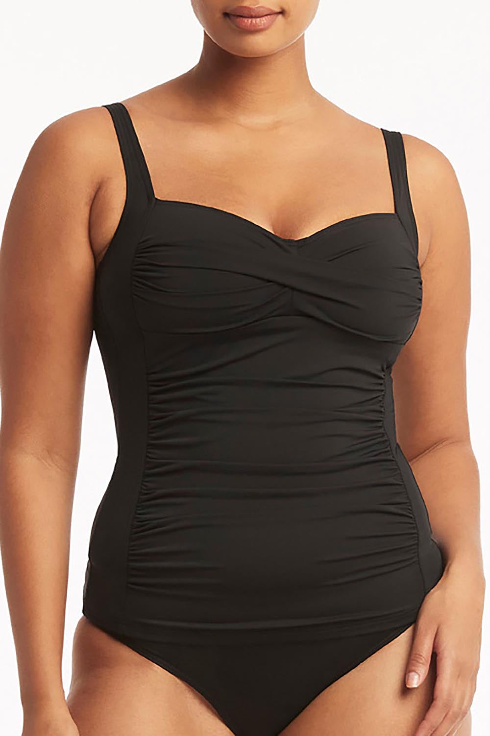 A model wearing the Twist Front Multifit Singlet Top in colour Black (Black), from the front, cropped image